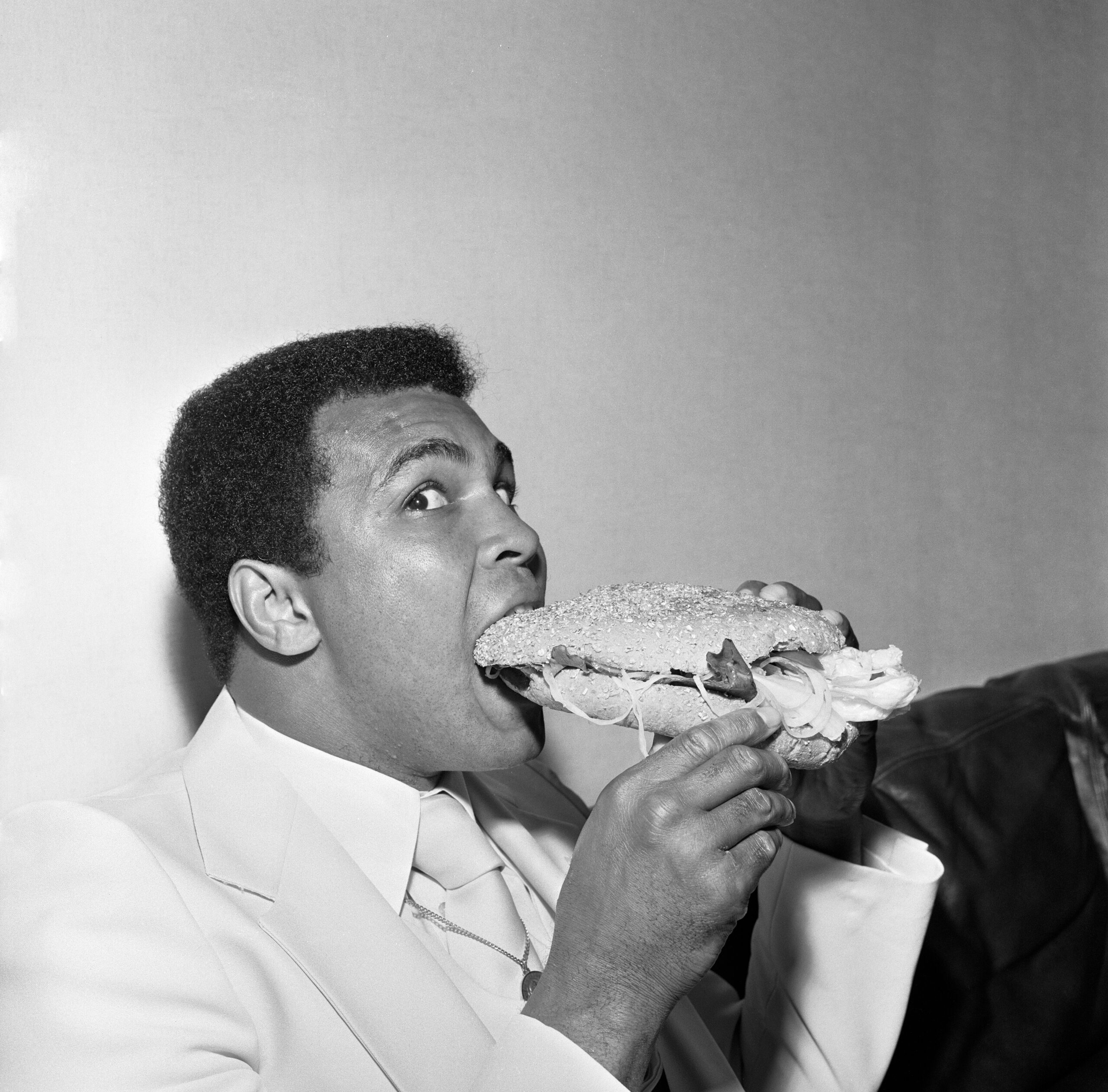 Muhammad Ali in Newcastle eating a Stottie cake 1977